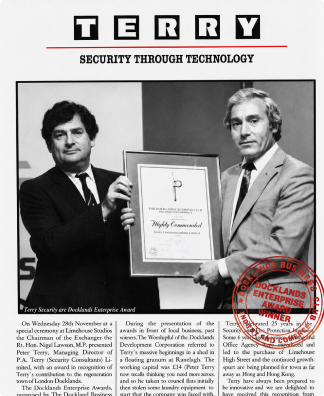 Two men holding a framed award certificate in a Terry security magazine feature